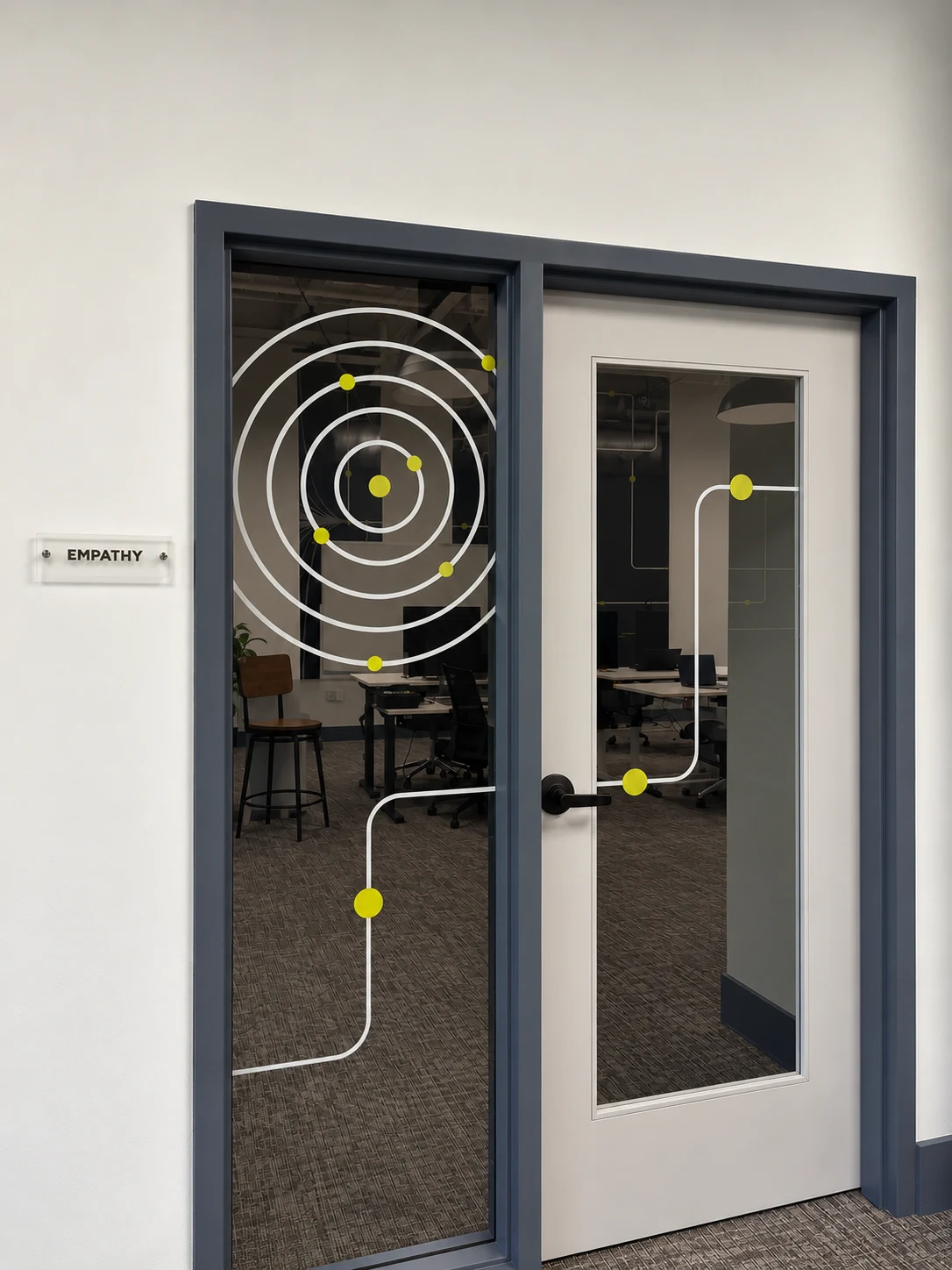 Empathy room door with window film of white orbit rings, a path line and lime dots