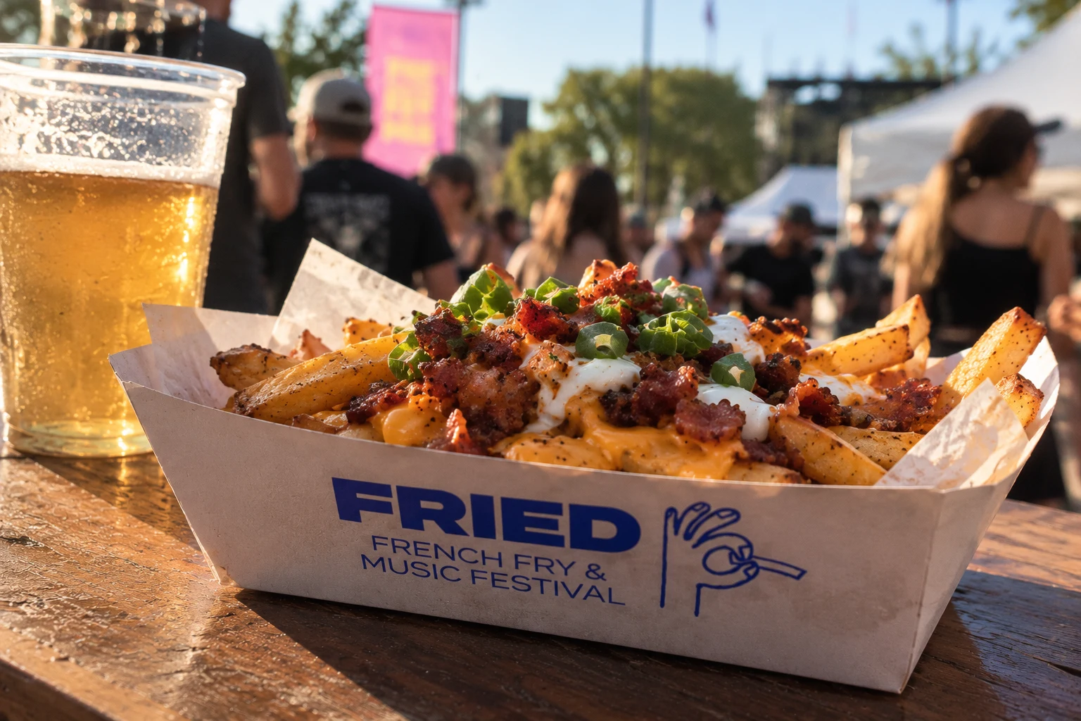 Loaded fries in a FRIED paper boat next to a beer