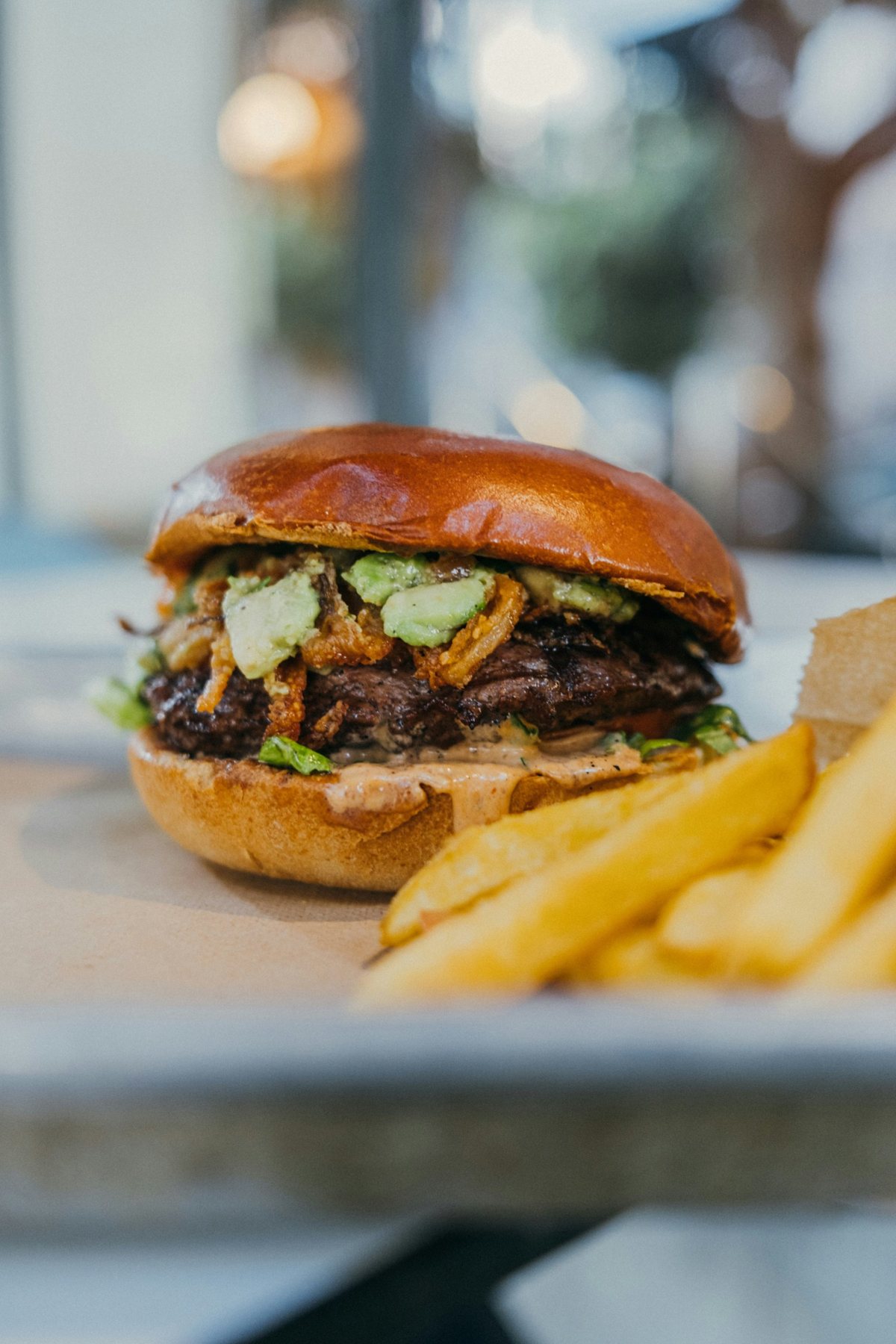 Burger with avocado and crispy onions