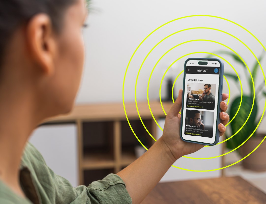 Hand holding a phone showing the Revive app, yellow circles radiating from it
