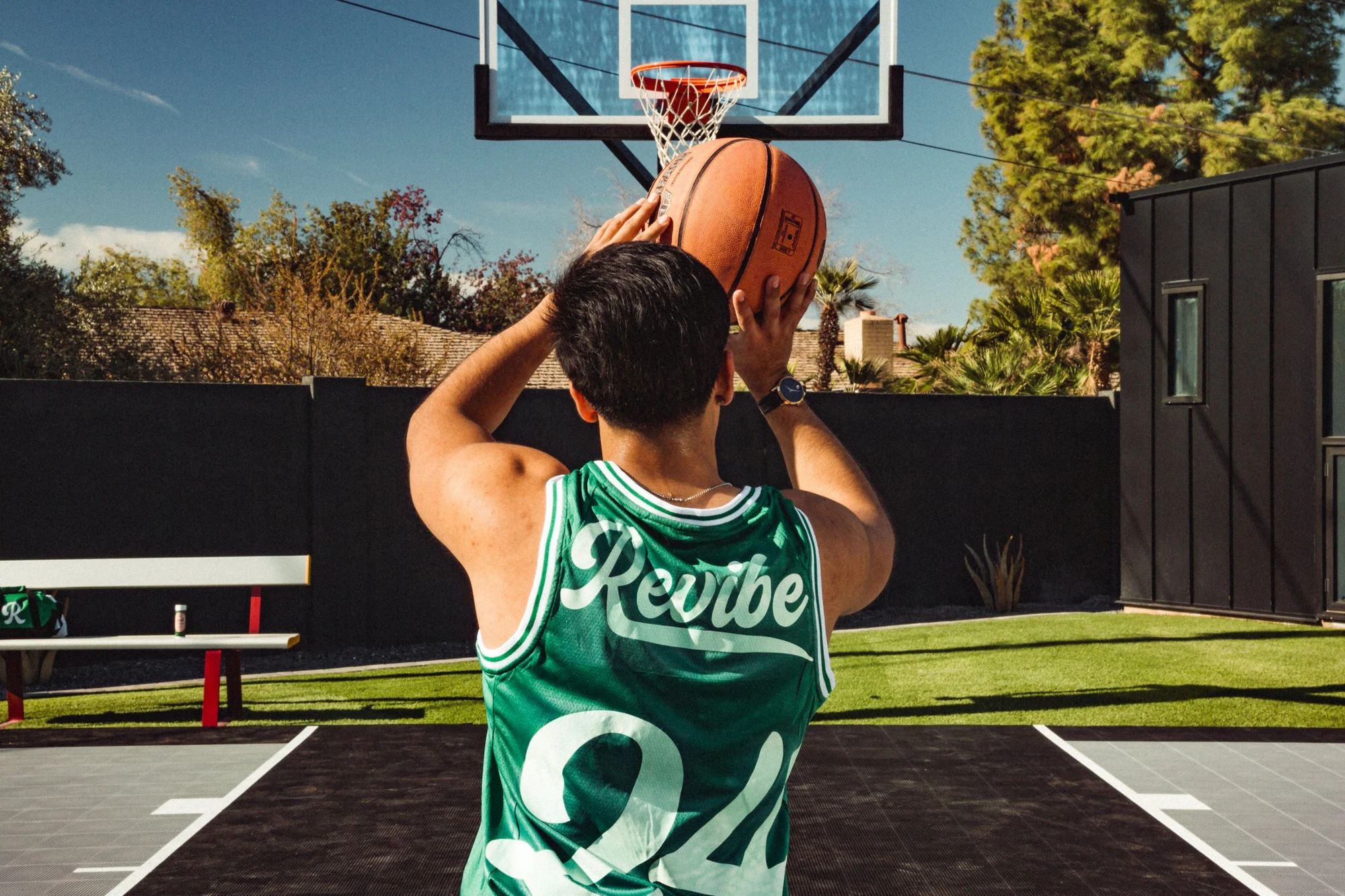 Player in a Revibe jersey shooting a basketball