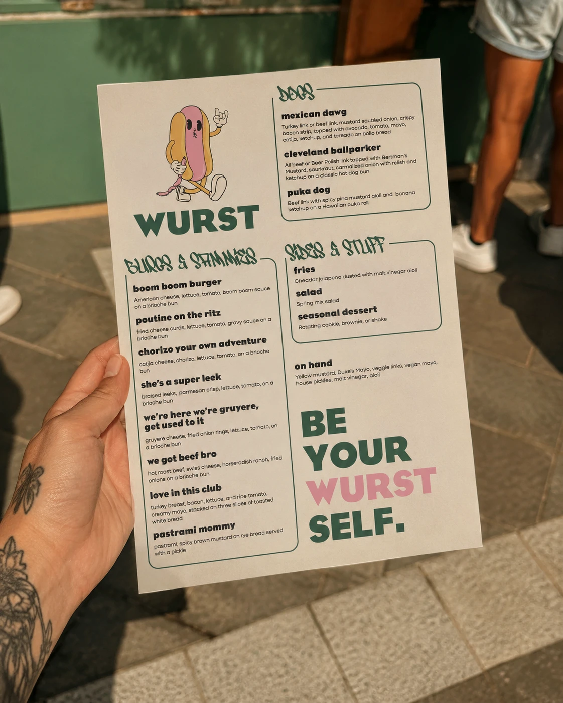 Wurst menu held up outside the stand