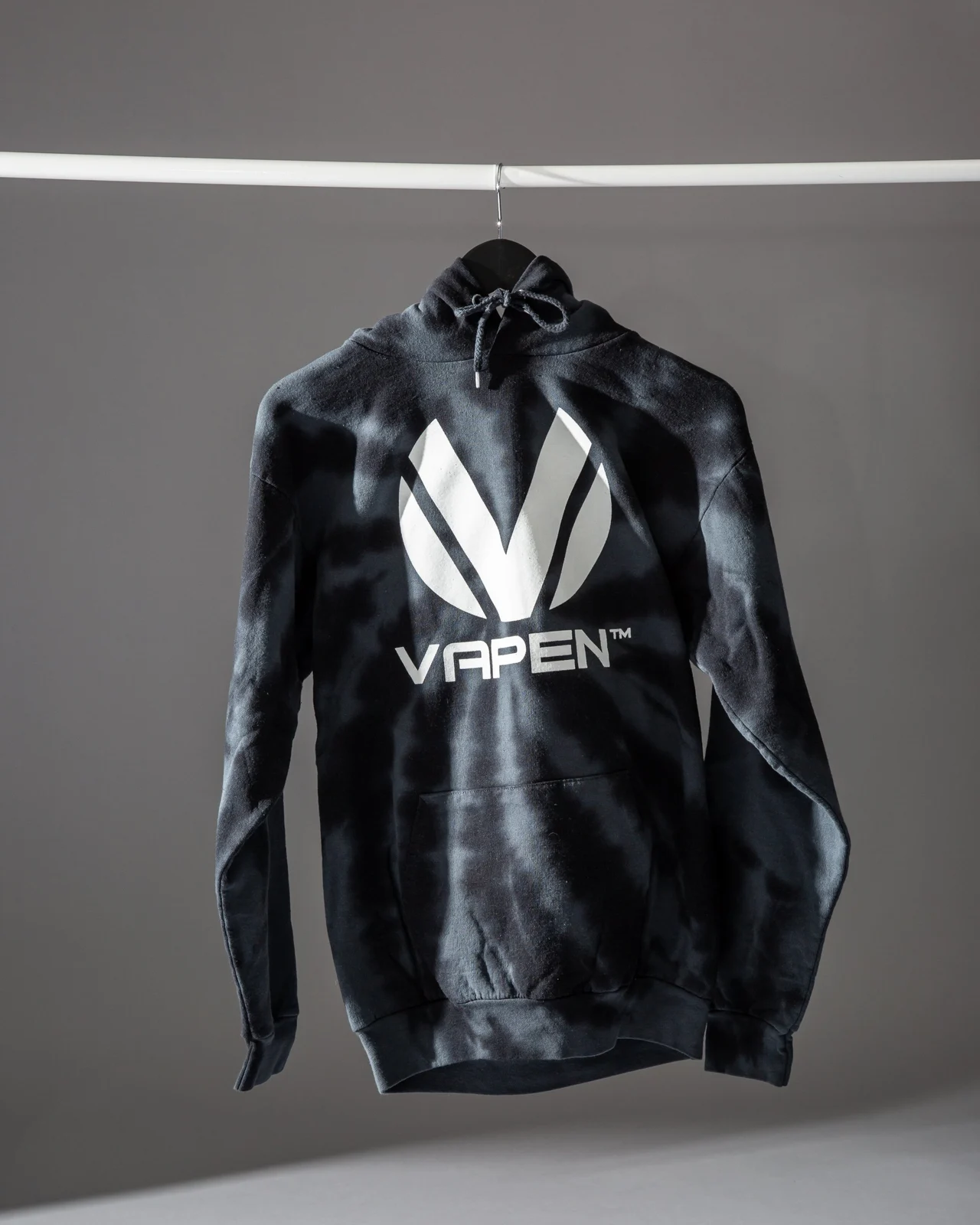 Vapen tie-dye hoodie on a hanger